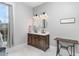 Bathroom featuring a double vanity, two round mirrors, and modern lighting at 1006 W Broad St, Dunn, NC 28334