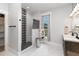 Bathroom with a walk-in shower, dual vanity, and modern lighting at 1006 W Broad St, Dunn, NC 28334