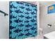Clean bathroom with a shower/tub and shark-themed curtain at 1006 W Broad St, Dunn, NC 28334