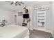 Cozy bedroom with a ceiling fan, built-in shelving, and a comfortable bed at 1006 W Broad St, Dunn, NC 28334