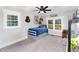 Charming bedroom with a twin bed, ceiling fan, and large windows at 1006 W Broad St, Dunn, NC 28334