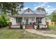 Charming white farmhouse with a front porch and brick steps at 1006 W Broad St, Dunn, NC 28334