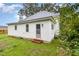 Rear view of a white sided home with access to backyard at 1006 W Broad St, Dunn, NC 28334