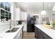 Bright kitchen featuring white cabinets, stainless steel appliances, and a kitchen island at 1006 W Broad St, Dunn, NC 28334