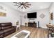 Open living room with a large TV and wood floors at 1006 W Broad St, Dunn, NC 28334