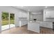 Bright kitchen with white cabinets, granite counters, and sliding door to patio at 1112 Middlecrest Dr, Rocky Mount, NC 27804
