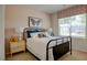 Cozy bedroom with a metal bed frame and window at 1133 Middlecrest Dr, Rocky Mount, NC 27804
