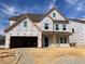 New two-story home under construction features a spacious layout and attached two-car garage at 116 Black Walnut Dr # 203, Garner, NC 27529
