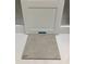 Close-up of interior selections: White cabinet door paired with a gray ceramic floor tile sample at 116 Black Walnut Dr # 203, Garner, NC 27529