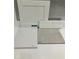 Interior selections: A white cabinet door, a white quartz countertop, and ceramic tile flooring sample at 116 Black Walnut Dr # 203, Garner, NC 27529