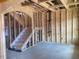Unfinished Living Room with a staircase leading to the second level at 116 Black Walnut Dr # 203, Garner, NC 27529