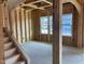 Unfinished Living Room with a staircase and an arched entrance at 116 Black Walnut Dr # 203, Garner, NC 27529
