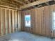 Unfinished Room showing exposed framing with windows and natural light at 116 Black Walnut Dr # 203, Garner, NC 27529