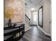 Spacious foyer with hardwood floors, large mirror, and a statement art piece at 1185 Atterlee Ln, Graham, NC 27253