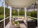 Relaxing screened porch with wicker furniture and wooded views at 1185 Atterlee Ln, Graham, NC 27253
