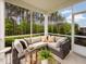 Screened porch features wicker furniture and lovely wooded views at 1185 Atterlee Ln, Graham, NC 27253