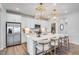 Bright kitchen featuring stainless appliances, white cabinetry, a quartz countertop island, and modern lighting at 1224 Hardin Hill Ln, Knightdale, NC 27545