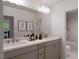 Bathroom has a double sink vanity with quartz countertop, a large mirror, decor and a tub shower at 1228 Hardin Hill Ln, Knightdale, NC 27545