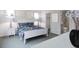 This bedroom has a floral duvet, white furniture and decor, windows and is next to a bathroom at 1228 Hardin Hill Ln, Knightdale, NC 27545