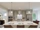 Modern kitchen featuring a large island with seating and stainless steel appliances at 1228 Hardin Hill Ln, Knightdale, NC 27545