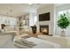 Open concept living room with a fireplace, large windows, and view into the kitchen at 1228 Hardin Hill Ln, Knightdale, NC 27545