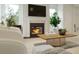 Cozy living room with a fireplace, large windows, and modern furniture at 1228 Hardin Hill Ln, Knightdale, NC 27545