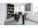 This office features a desk, bookshelf, decor, a comfortable seat and bright light from the windows at 1228 Hardin Hill Ln, Knightdale, NC 27545
