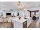 Bright, open-concept kitchen featuring a spacious island with seating, modern lighting, and hardwood flooring at 1252 Hardin Hill Ln, Knightdale, NC 27545
