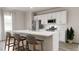 Modern kitchen with white cabinets, an island, and stainless steel appliances at 1279 Willow Tree Way, Graham, NC 27253