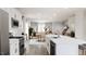 Open concept kitchen features island, white cabinets and stainless steel appliances at 1279 Willow Tree Way, Graham, NC 27253