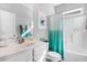 Clean bathroom with white vanity, bathtub, and teal shower curtain at 142 Jade St, Smithfield, NC 27577