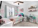 Charming bedroom with a teal headboard and decorative shelving at 142 Jade St, Smithfield, NC 27577