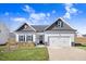 Two-story Craftsman home with gray and white exterior, two-car garage, and landscaping at 142 Jade St, Smithfield, NC 27577