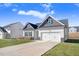 Newly built home with gray and white exterior, two-car garage, and landscaping at 142 Jade St, Smithfield, NC 27577