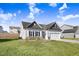 Modern two-story house with gray and white exterior, two car garage and grassy yard at 142 Jade St, Smithfield, NC 27577