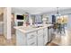 Kitchen island with white cabinets and a view into the dining and living areas at 142 Jade St, Smithfield, NC 27577