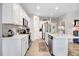 Modern kitchen boasts white cabinets, kitchen island, and stainless steel appliances at 142 Jade St, Smithfield, NC 27577