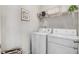 Laundry room with washer, dryer, and shelving unit at 142 Jade St, Smithfield, NC 27577