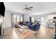 Open concept living space with L-shaped sectional sofa, large windows, and hardwood floors at 142 Jade St, Smithfield, NC 27577