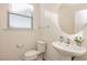 Clean powder room with pedestal sink, toilet and an oval mirror at 1609 Mallard Trace Dr, Wendell, NC 27591
