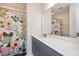 Bathroom with shower/tub combo, double vanity, and floral shower curtain at 1609 Mallard Trace Dr, Wendell, NC 27591