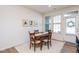 Bright dining room with wooden table and four chairs at 1609 Mallard Trace Dr, Wendell, NC 27591