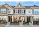 Three-story townhouses with stone accents and front porches at 1609 Mallard Trace Dr, Wendell, NC 27591