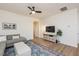 Living room with sectional sofa, media console, and ceiling fan at 1609 Mallard Trace Dr, Wendell, NC 27591