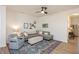 Living room with sectional sofa, ottoman, and ceiling fan at 1609 Mallard Trace Dr, Wendell, NC 27591