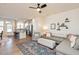 Spacious living room boasts hardwood floors, an L-shaped sofa, and views into the kitchen at 1609 Mallard Trace Dr, Wendell, NC 27591