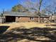 Exterior rear view of brick home featuring fenced yard and mature trees at 1641 Bridgedale Dr, Rocky Mount, NC 27803