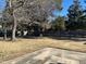 Backyard featuring concrete patio and grass yard with mature shade trees and privacy fence at 1641 Bridgedale Dr, Rocky Mount, NC 27803