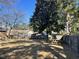 Large backyard features a mature shade tree, picnic table, and a wood privacy fence at 1641 Bridgedale Dr, Rocky Mount, NC 27803