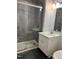 Bathroom with tile shower, tile flooring, white vanity, mirror and updated fixtures at 1641 Bridgedale Dr, Rocky Mount, NC 27803